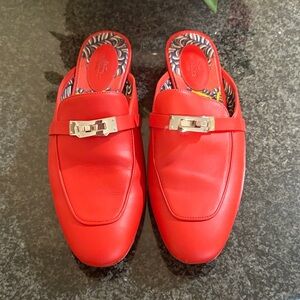 Hermes Orange Leather Slip-On Loafers with Silver Buckle.